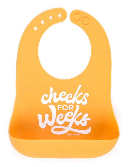 Wonder Bib | Cheeks For Weeks silicone baby bib with adjustable neck and food-catching pocket in bright orange.