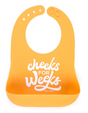 Wonder Bib | Cheeks For Weeks silicone baby bib with adjustable neck and food-catching pocket in bright orange.