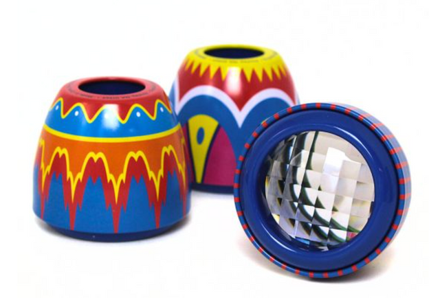 Three colorful tin Fly’s Eyes with vibrant patterns and faceted lenses shown from different angles.