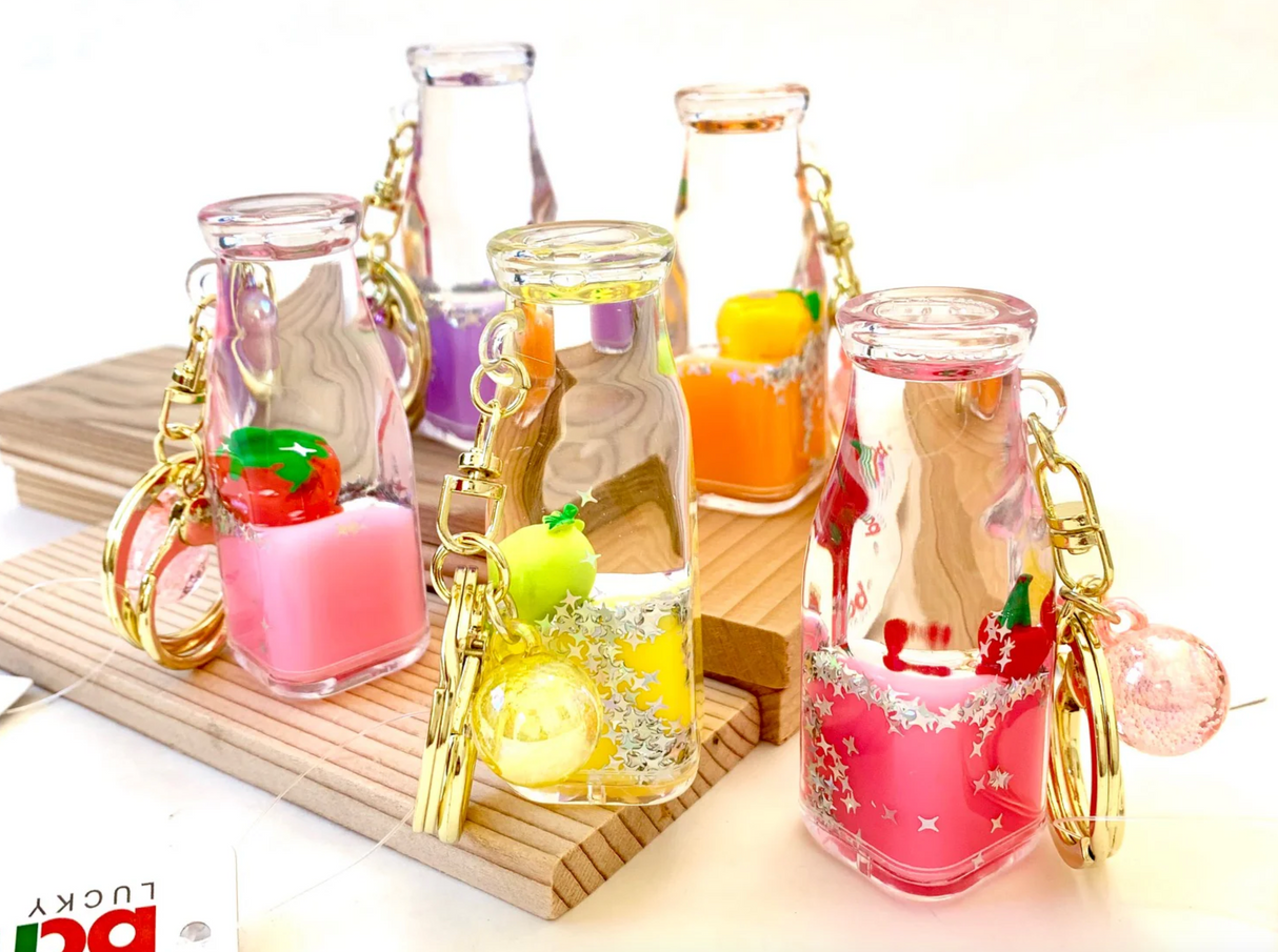 Fruit Bottle Floaty KeyChain in assorted colors with floating fruit charms and gold key rings, perfect for pool parties.