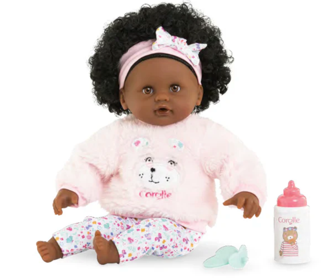 Calin Caroline Set baby doll with soft vinyl limbs, curly hair, pink outfit, headband, and feeding accessories.