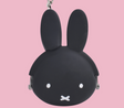 mimi POCHI BABY Miffy Pouch | Black mini silicon coin case with Miffy face and clip-open closure against pink background
