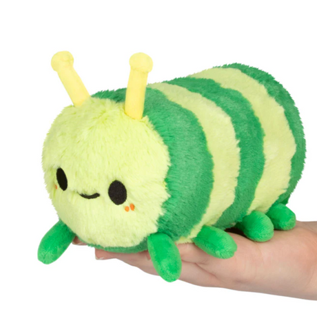 Soft plush Snacker Caterpillar toy with green stripes and friendly face held in hand.