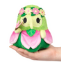Alter Ego | Plague Doctor Nymph plush with green and pink petals and flower crown held in hand.