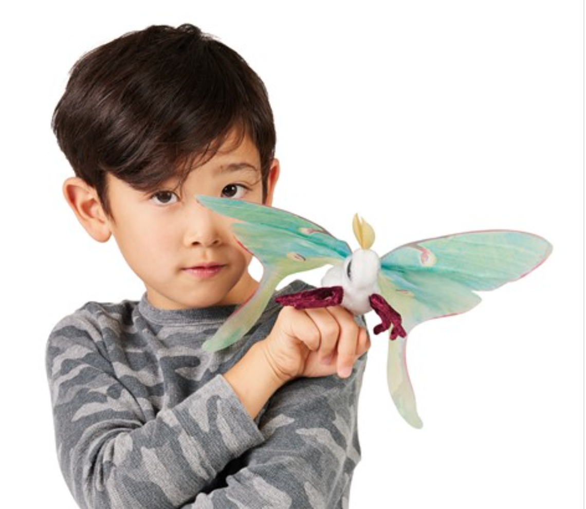 Child playing with the Luna Moth Finger Puppet featuring delicate organza wings and a velvet body on his finger.