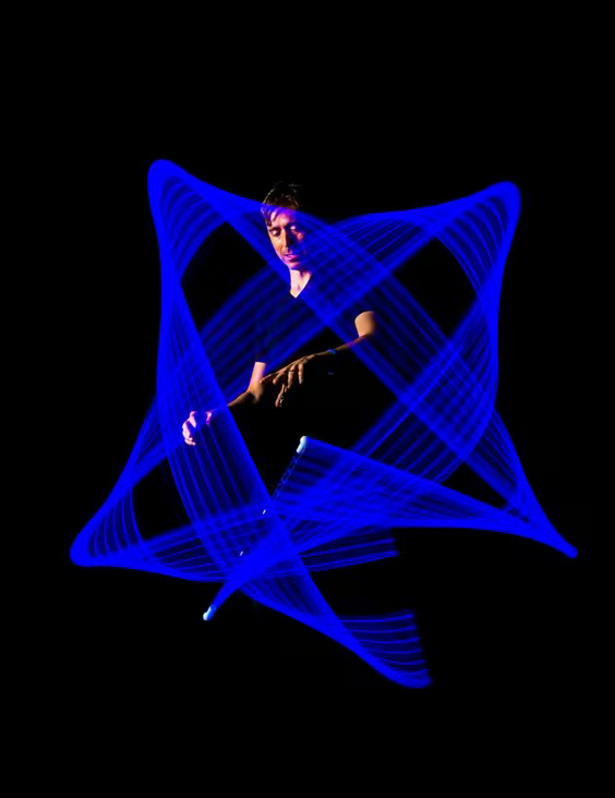 Person creating mesmerizing blue light patterns at night using Wandini Glow Wand levitating LED wand.