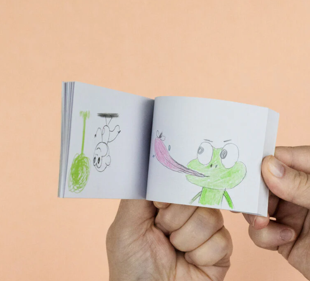Flip Book Kit | Animation in Action showing hand-held flip book with animated frog and bee sketches.