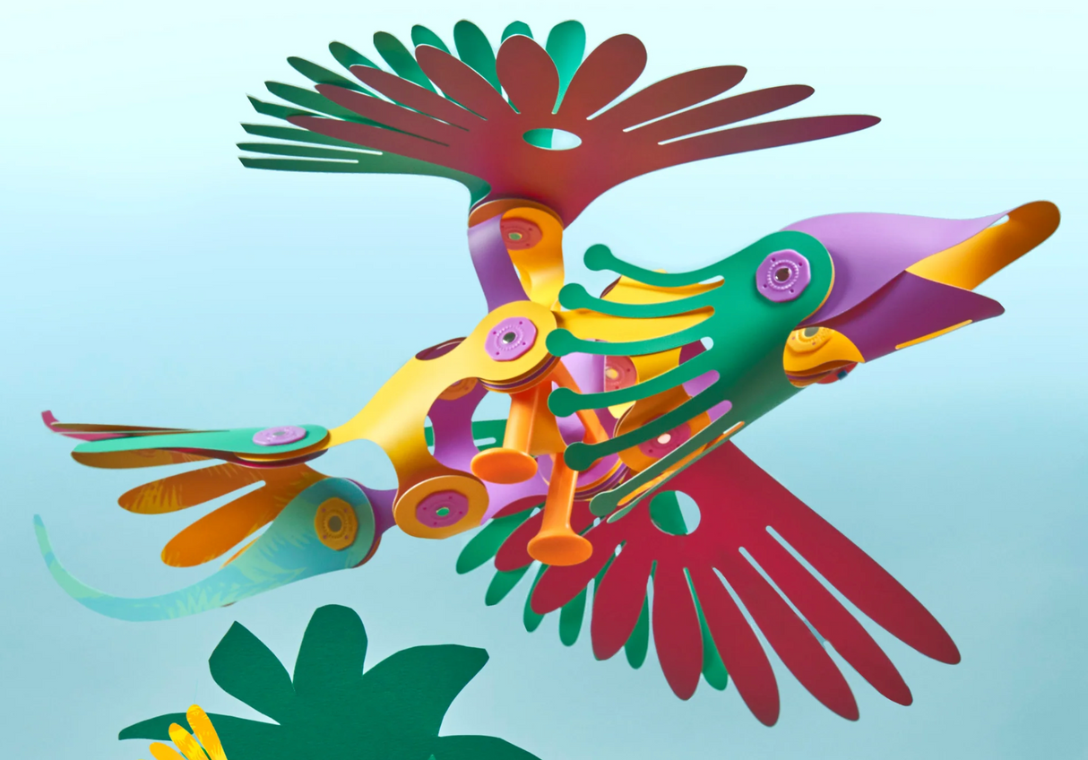 Clixo | Tropical Birds Pack colorful tropical bird model with wing-flapping mechanism against a blue sky background