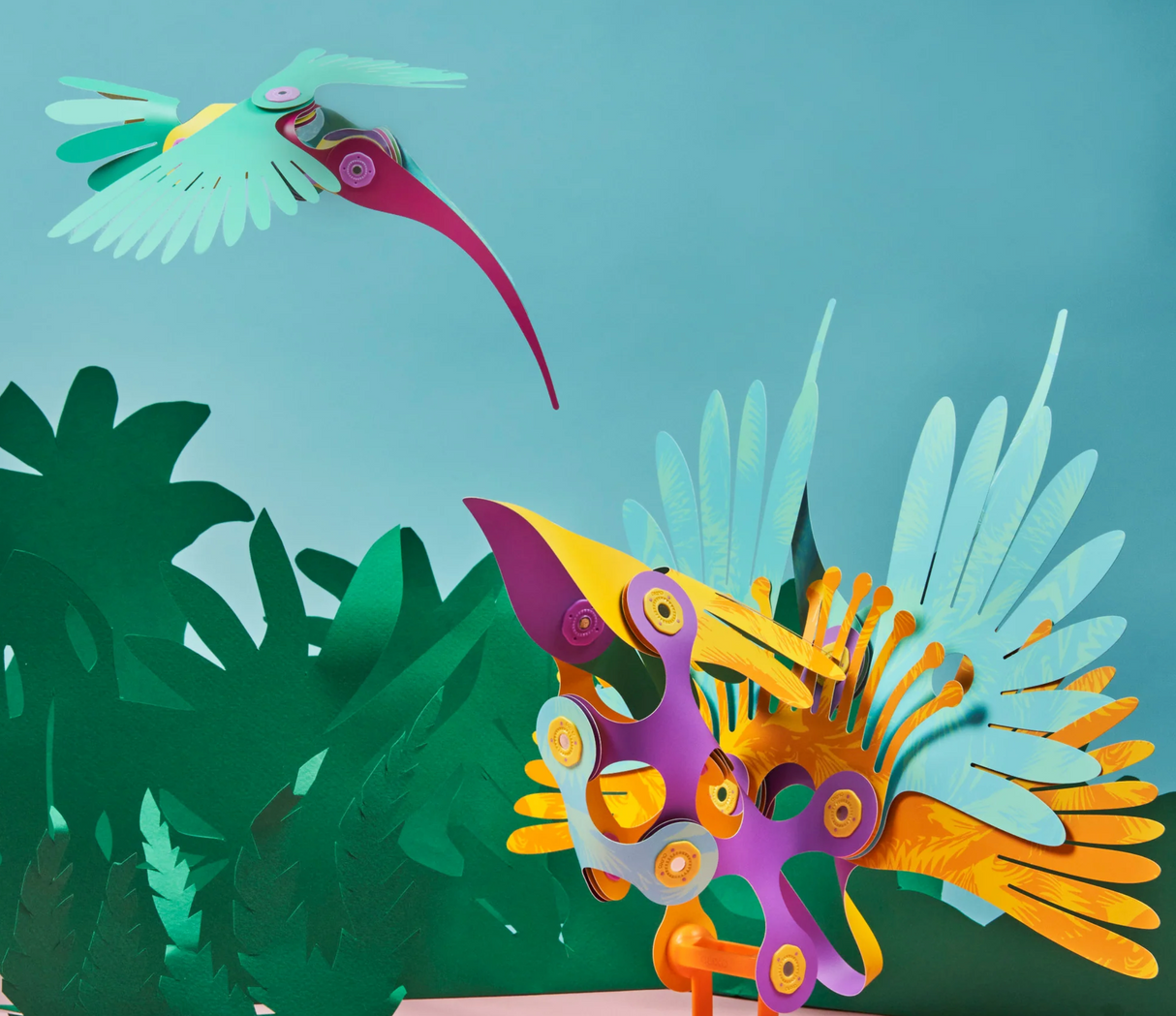 Colorful bird models with wing-flapping parts from Clixo | Tropical Birds Pack against a jungle backdrop.