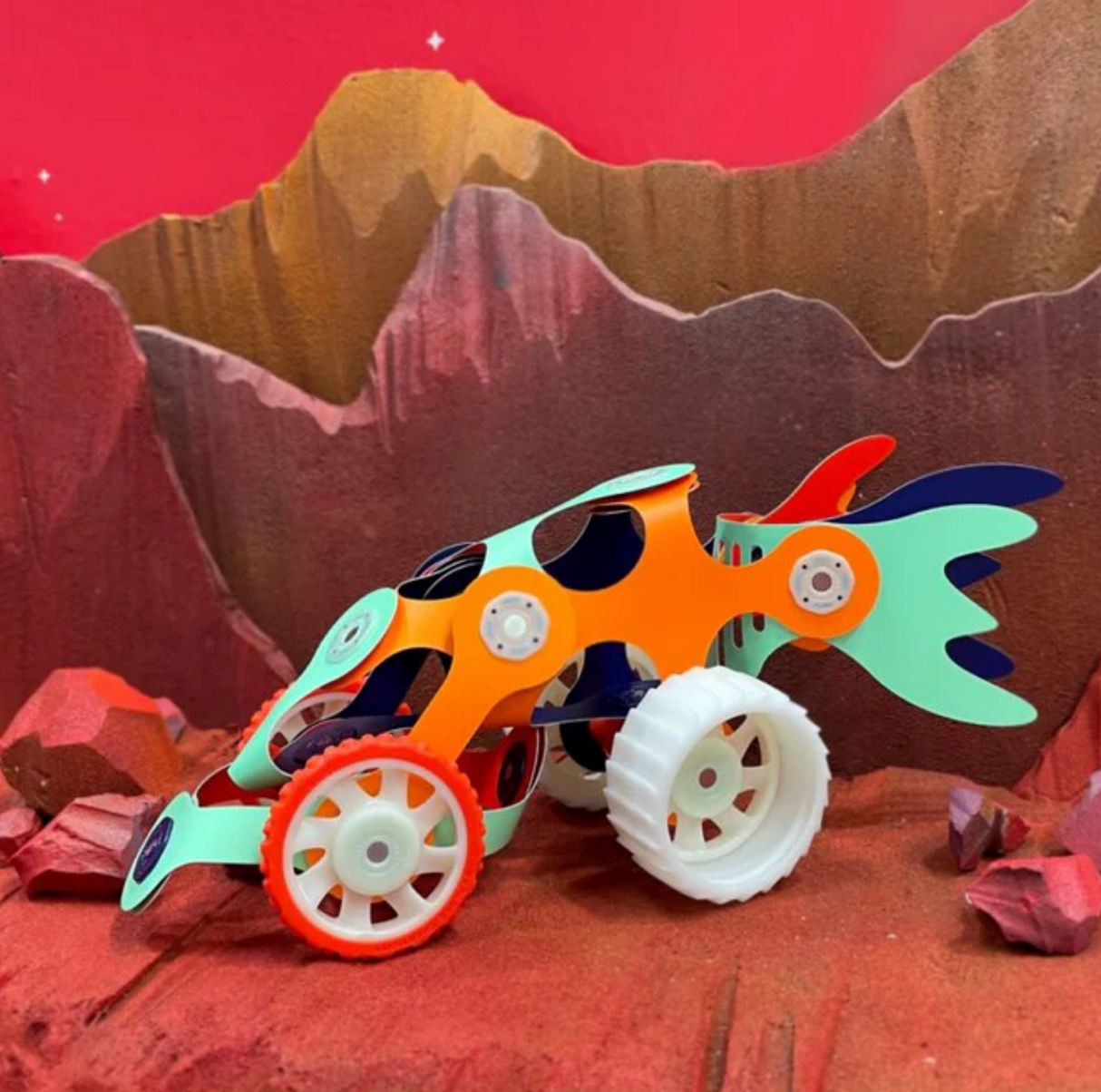 Clixo | Mars Rover Pack flexible magnetic rover with all-terrain wheels on a red Martian landscape background.