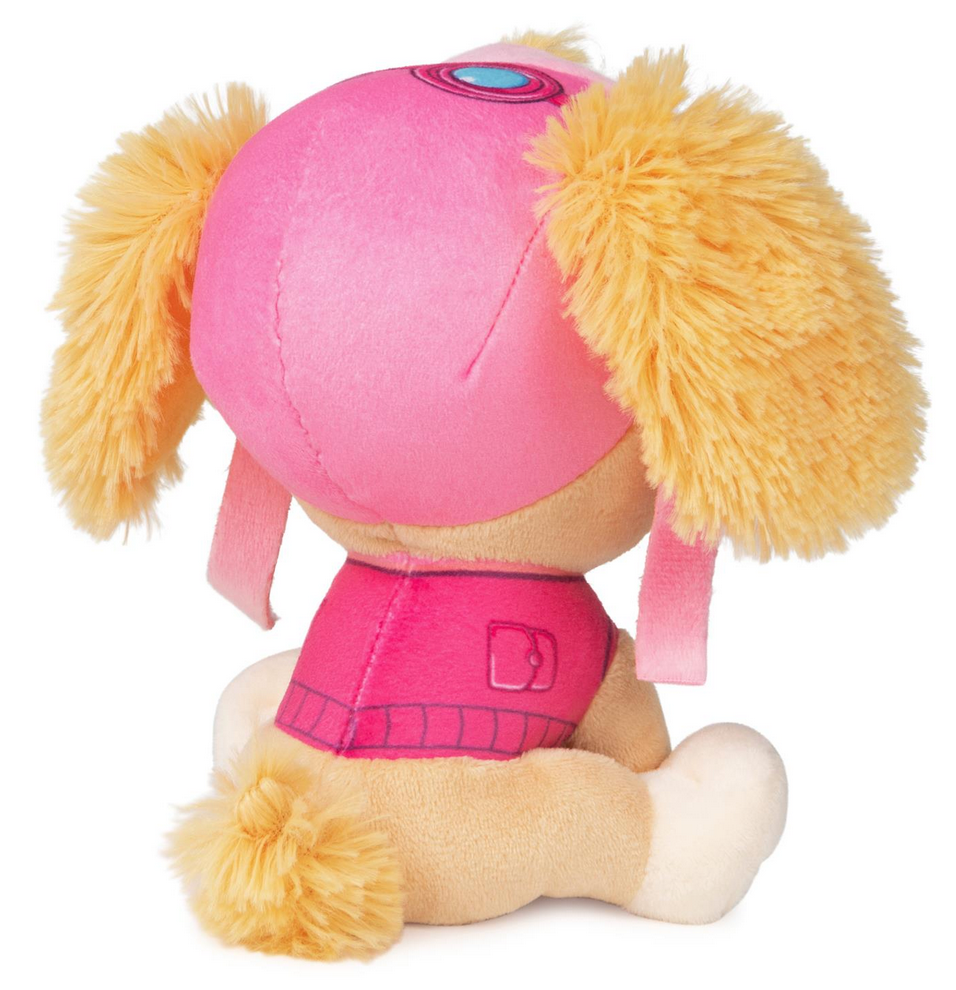 Paw Patrol Skye plush toy in pink aviator hat and jacket with fluffy ears sitting facing away.