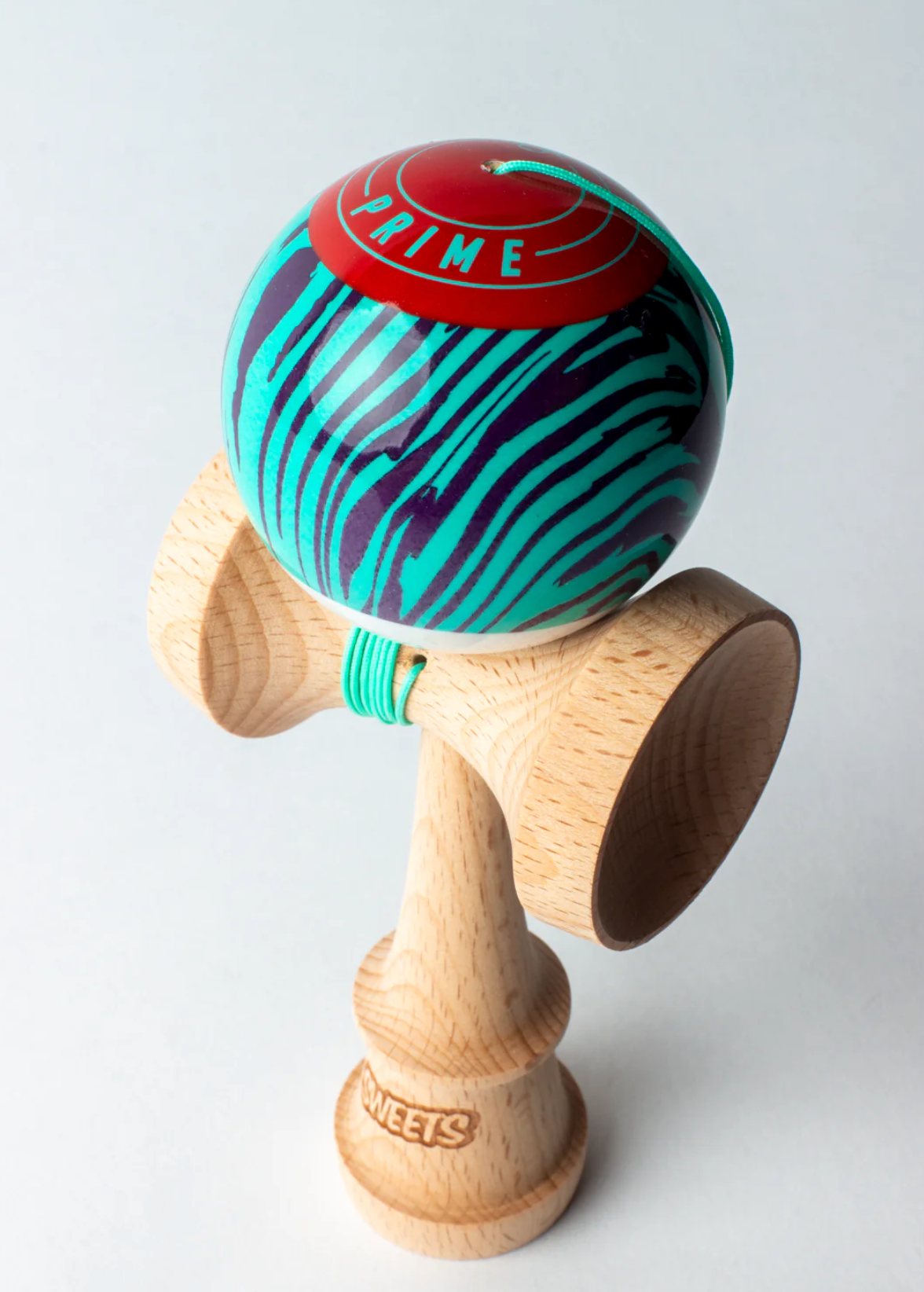 Kendama Prime Grain Split | Laser Tag with wood grain design, red top, and turquoise string on natural wood body.