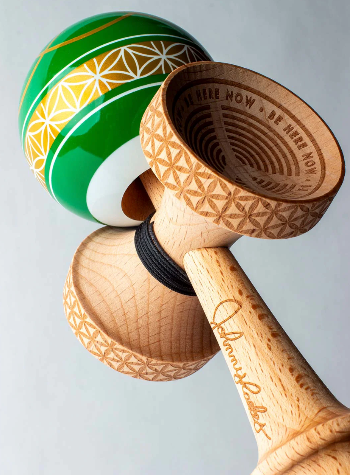 Kendama Johnny Raekes V2 BS Sticky with green and yellow tama and engraved wooden cups and handle close-up.