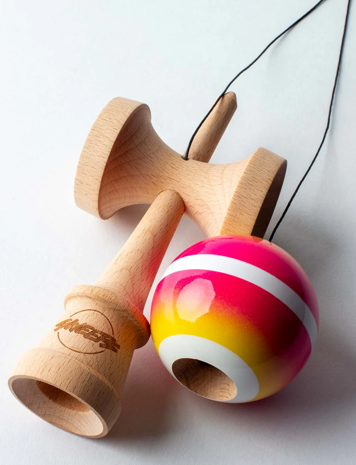 Kendama Horizon Fade | Pink/Yellow with wooden ken and vibrant pink to yellow fade tama featuring a white center stripe.