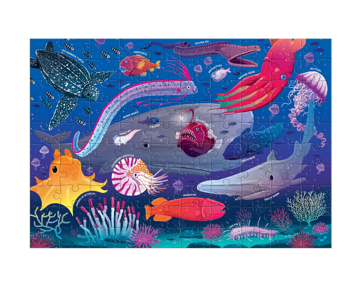 100pc Deep Sea Puzzle showing colorful underwater creatures including fish, jellyfish, coral, turtle, and deep sea animals.