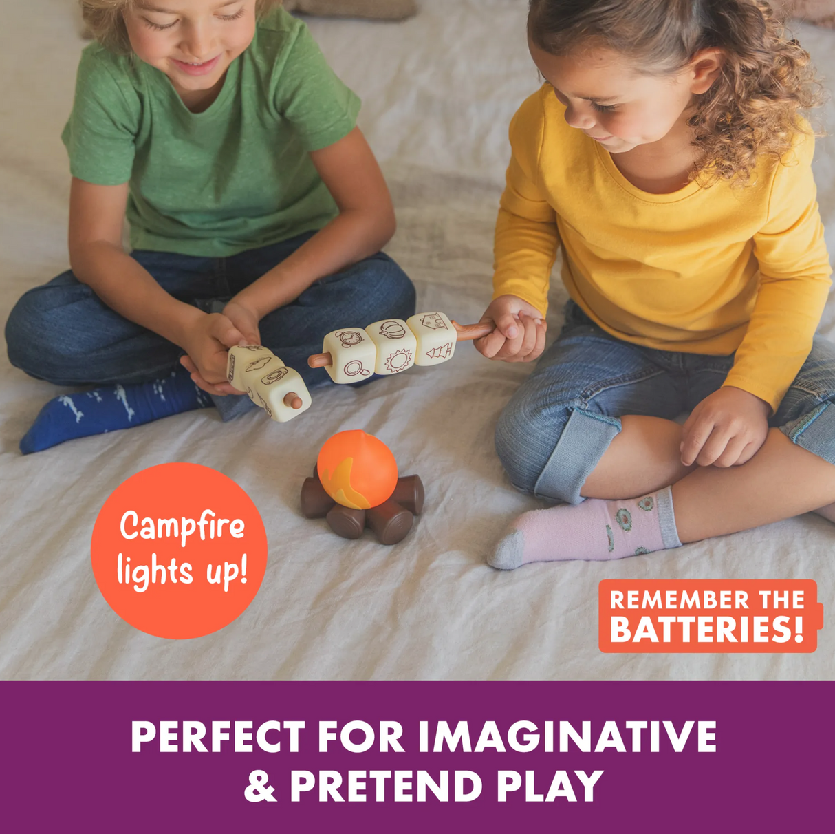 Two children playing with Campfire Chatmallows storytelling game featuring LED campfire and story starter icons.