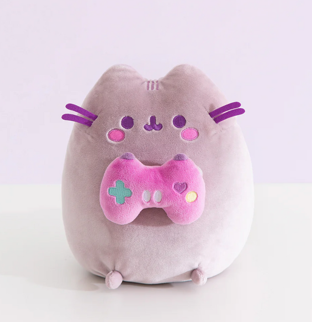 Pusheen Gamer plush features a soft purple-gray cat holding a bright pink console controller with embroidered details.