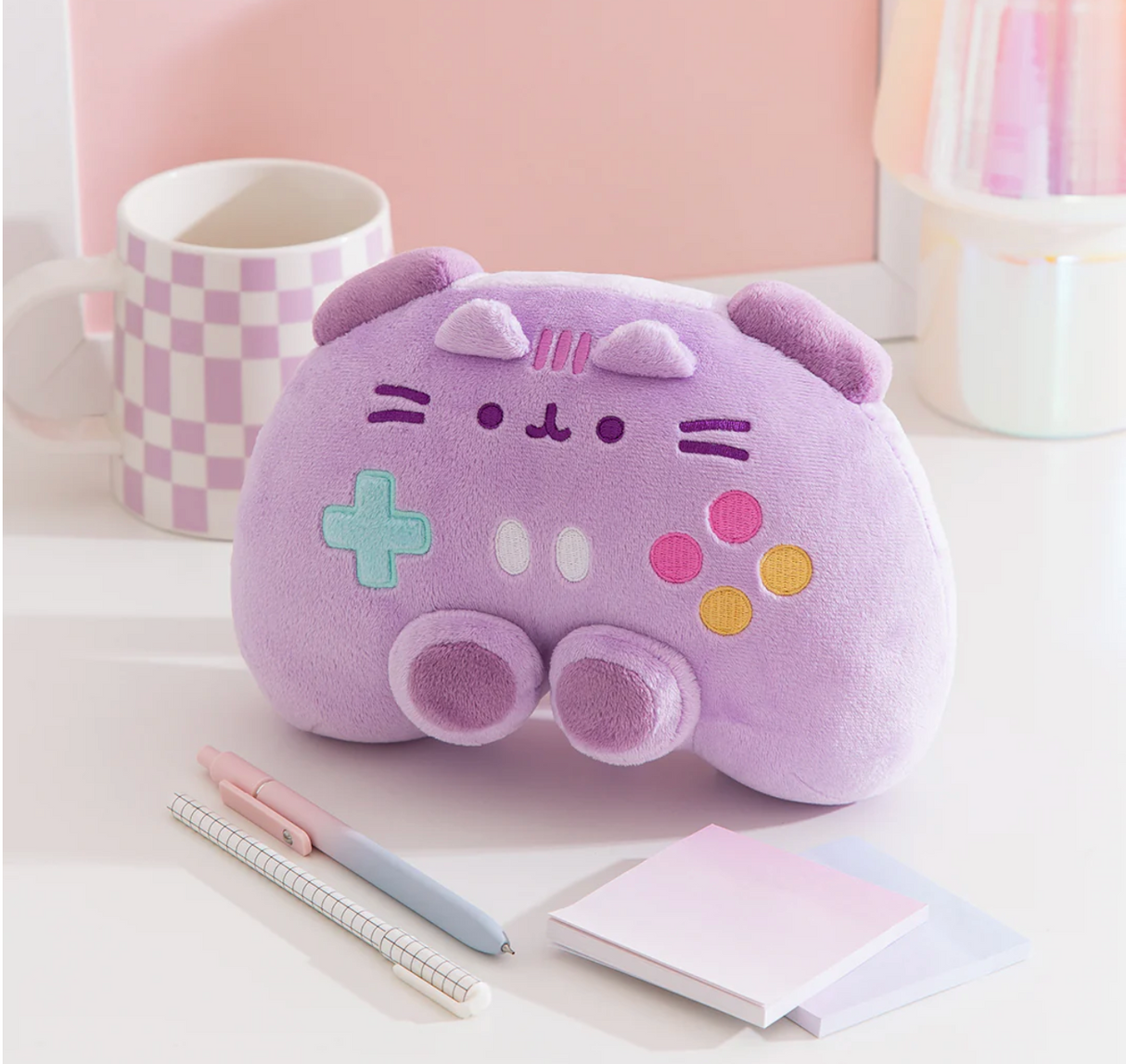 Pusheen Gamer: Controller plush in soft lavender with embroidered buttons, whiskers, and cozy gaming design for kids 8 and up.