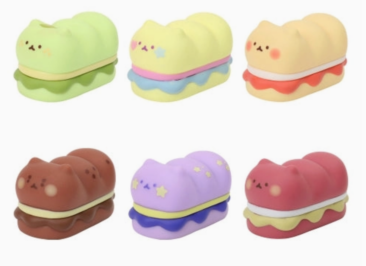 Six pastel-colored cat figures shaped like fluffy cats sandwiched between dessert buns arranged on a white background