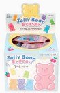 Box of colorful gummy bear-shaped erasers individually wrapped in pastel pink gingham packaging with playful design details