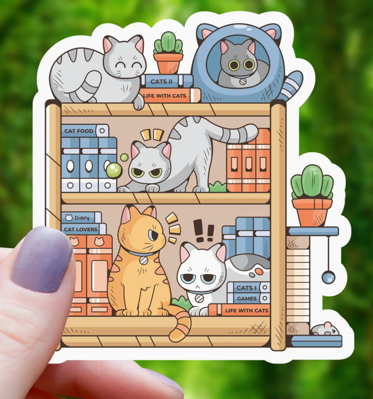Hand holding a cute sticker of a bookshelf filled with playful cartoon cats and colorful books and plants