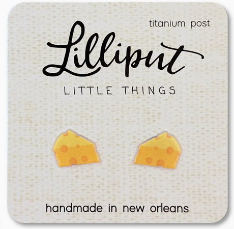 Small handmade cheese wedge stud earrings with titanium posts on a textured card from Lilliput Little Things