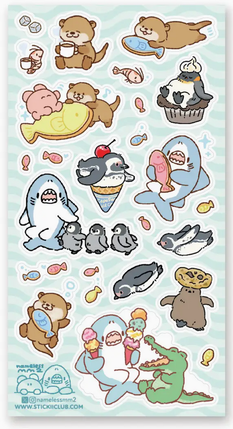 Cute ocean-themed stickers featuring otters, sharks, penguins, and an alligator with playful treats and fish designs