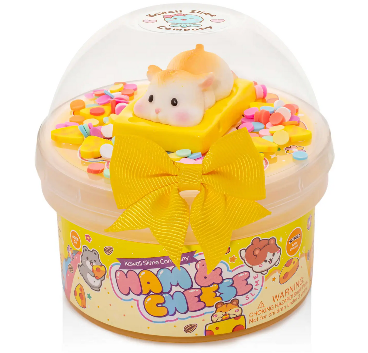 Clear container of glossy yellow slime with colorful sprinkles, a cute hamster on cheese charm, and a yellow bow on the lid