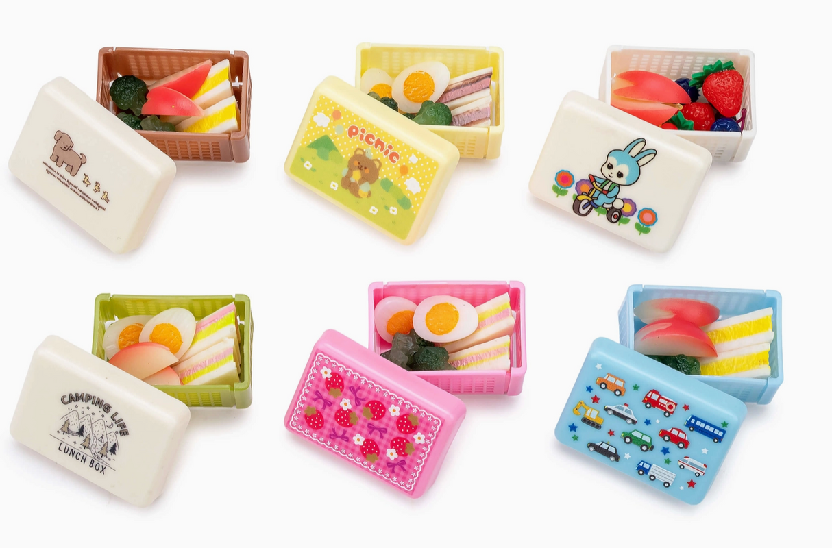 Six colorful foldable lunch boxes with charming surprise figures and miniature food designs inside each capsule container.