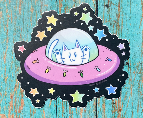 Whimsical sticker of a cat piloting a pink UFO surrounded by colorful stars on a textured blue background