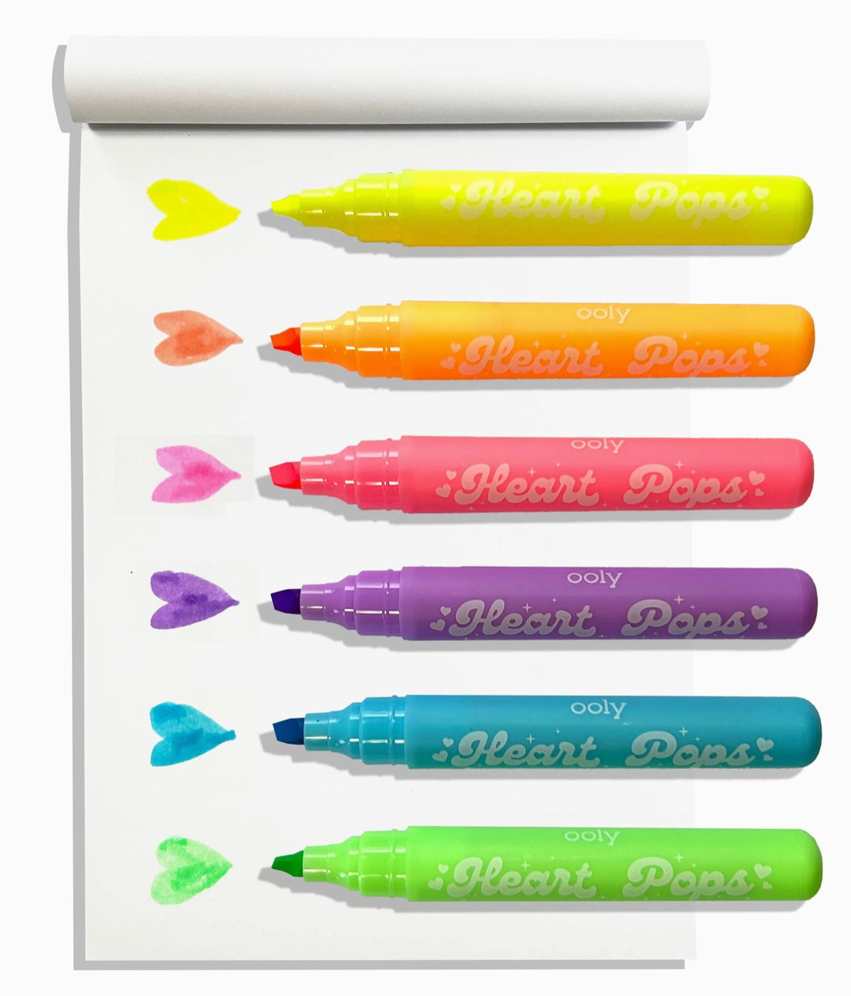 Six colorful Heart Pops neon highlighters with heart-shaped marks on white notepad paper
