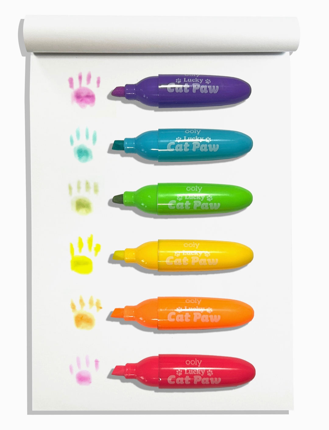 Set of six colorful Lucky Cat Paw Neon Highlighters with paw print marks on white notepad page