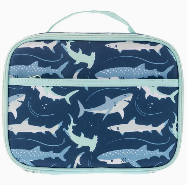 Junior lunchbox with fun shark pattern, insulated and waterproof with extra storage pockets and a light blue trim.