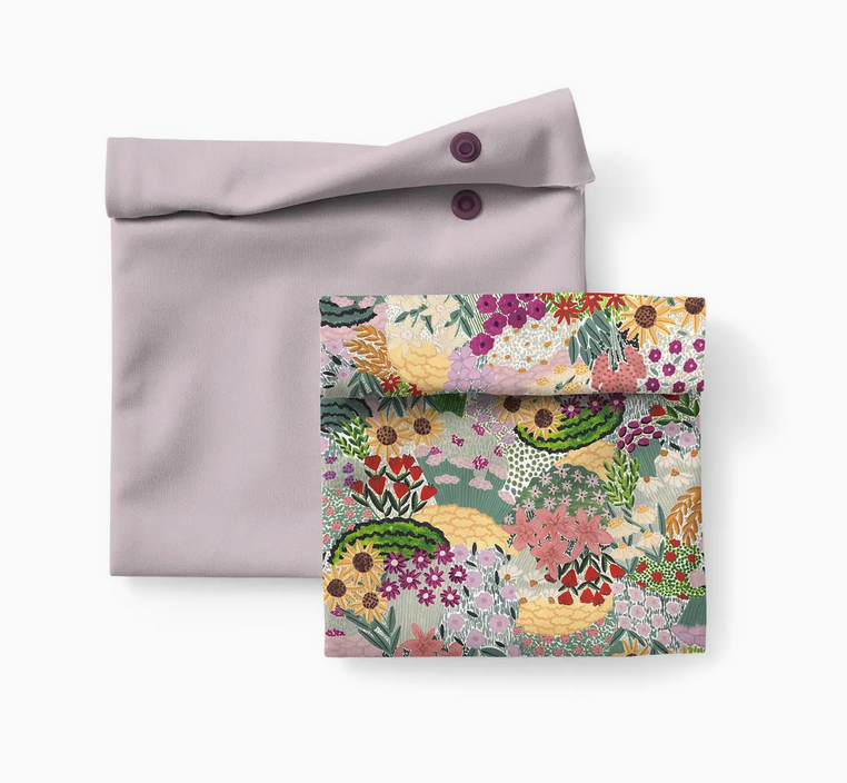 Two reusable snack pouches, one solid lavender and one floral print with snap closures for eco-friendly lunch storage