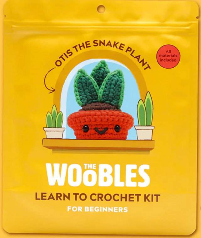 Bright yellow pouch featuring Otis the Snake Plant crochet kit with red pot and smiling face for beginner crafters