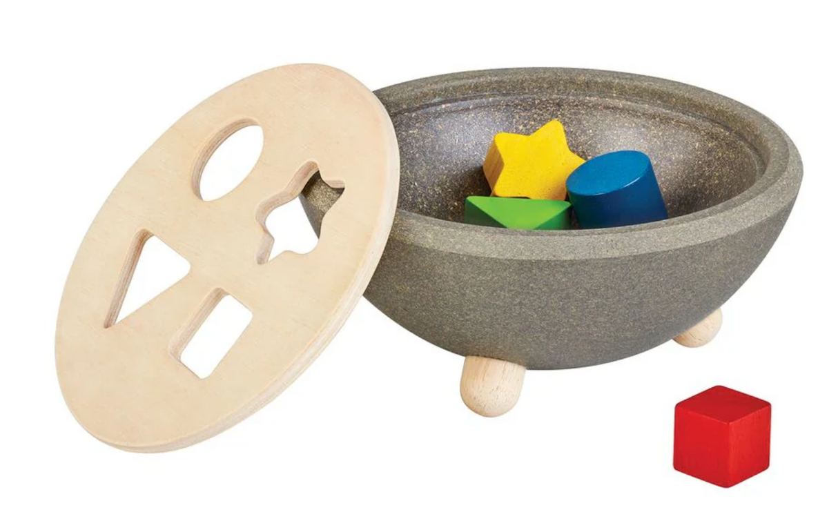 Wooden shape sorting bowl with colorful geometric puzzle pieces for early learning and coordination development