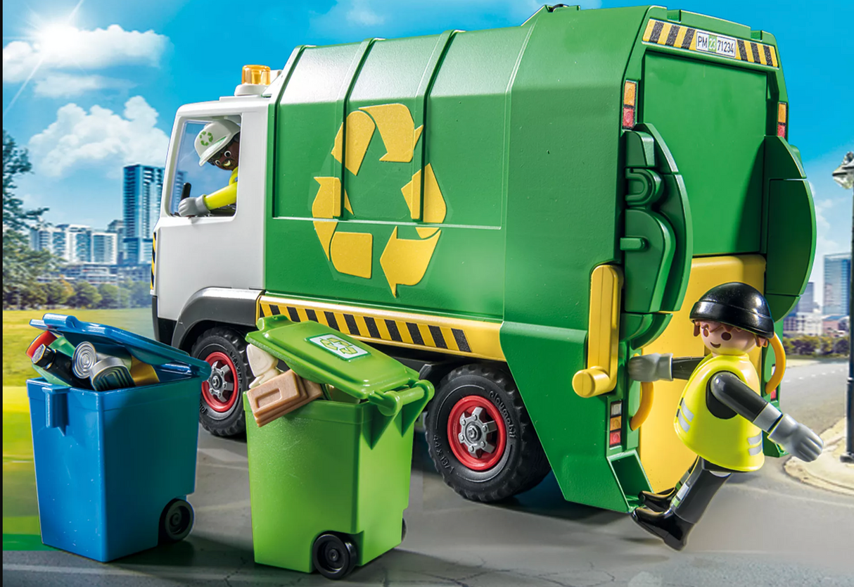 PLAYMOBIL recycling truck with two sanitation workers emptying bins filled with garbage and recyclables on city street.