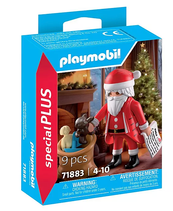 Santa figure holding wishlist next to sack with toys in festive room with Christmas tree and fireplace