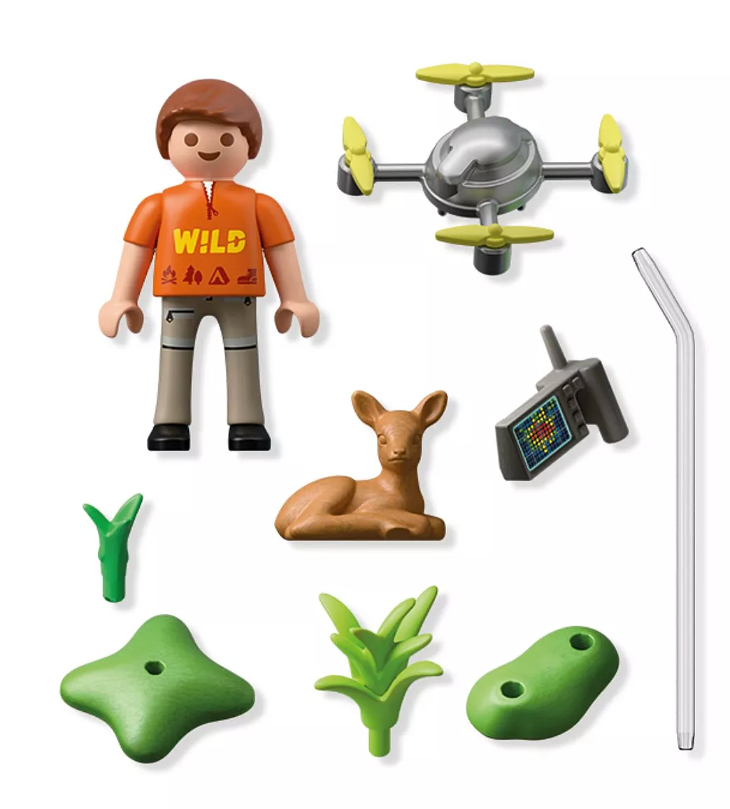 Explorer figure with drone, small fawn, walkie-talkie, and forest plants from rescue playset for kids.