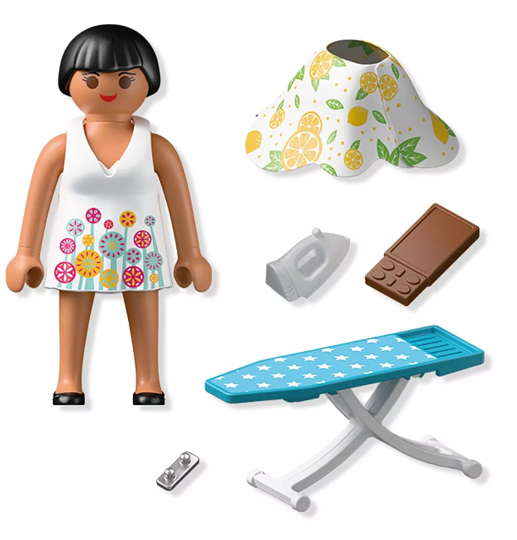 Playmobil Stylist figure with ironing board, iron, fabric piece, chocolate, and accessories for creative play.