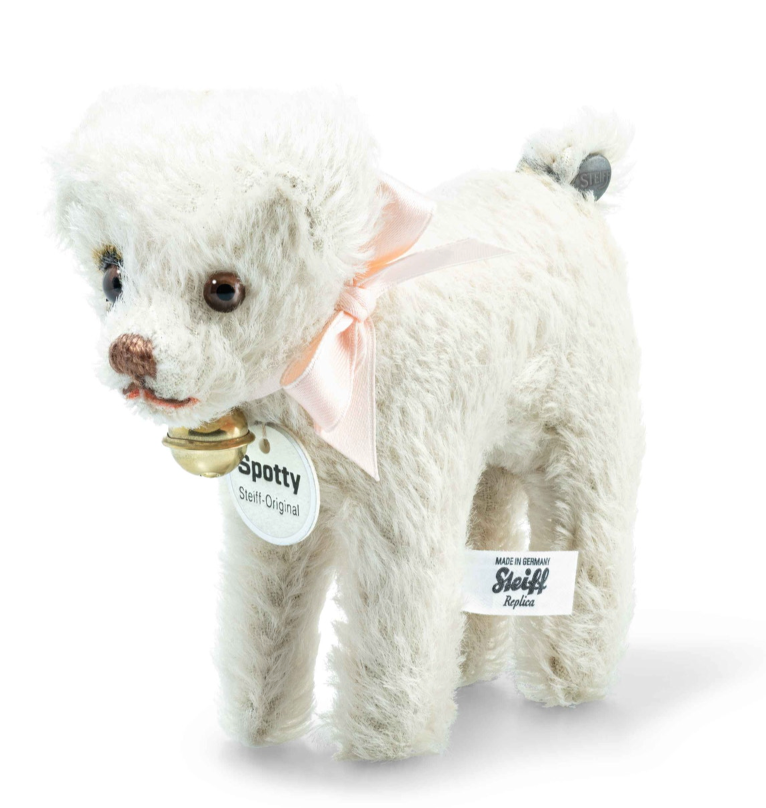 Soft white plush Fox terrier dog with pink bow, bell, and Steiff Replica tag on white background