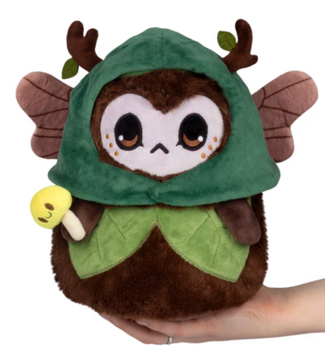 Handheld plush dark forest fae mini with green hood, antlers, wings, and a small yellow mushroom accessory