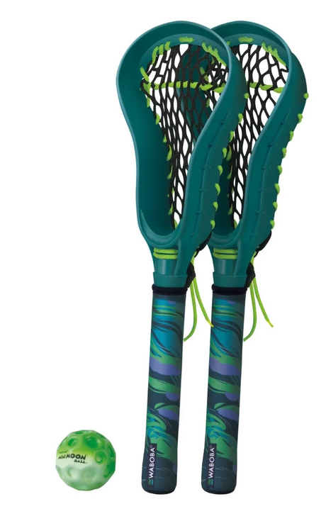 Two green mini lacrosse sticks with black nets and a green Waboba Moon Ball for street play and practice.