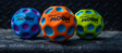 Three colorful high-bounce Waboba Moon Balls with crater grip design on a textured dark surface