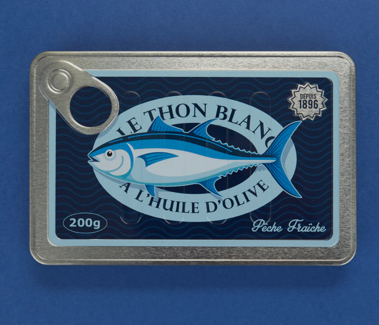 Notebook designed to look like a vintage sardine tin with metal edges and a blue fish label on the cover