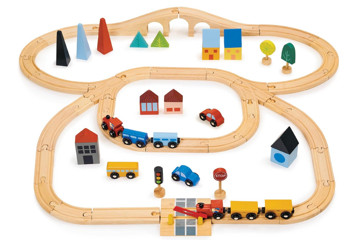 Wooden town train set with tracks, colorful buildings, vehicles, trees, and a working railway crossing barrier