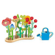 Flower Bed wooden toy with colorful plywood plants and blue watering can for interactive planting and growth.