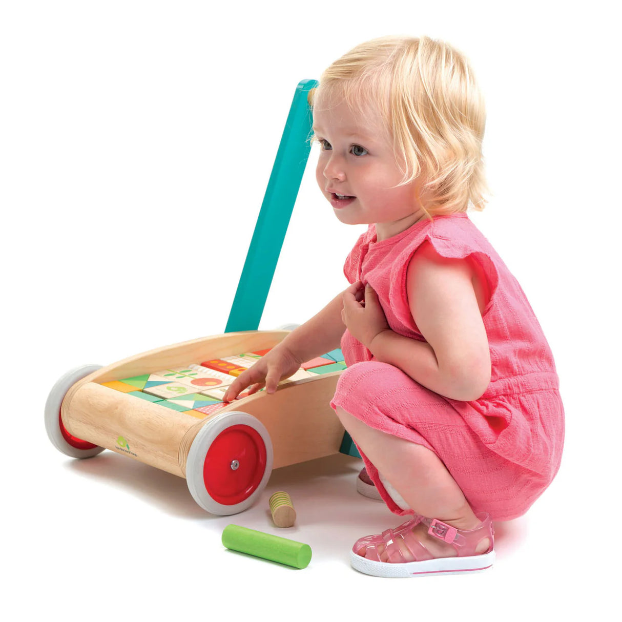 Toddler playing with Baby Block Walker wooden walker featuring colorful garden themed blocks for creative play.