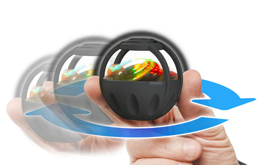 Hand spinning the Thumbler, a handheld light-up fidget sphere showing gyroscopic motion and swirling LED colors.