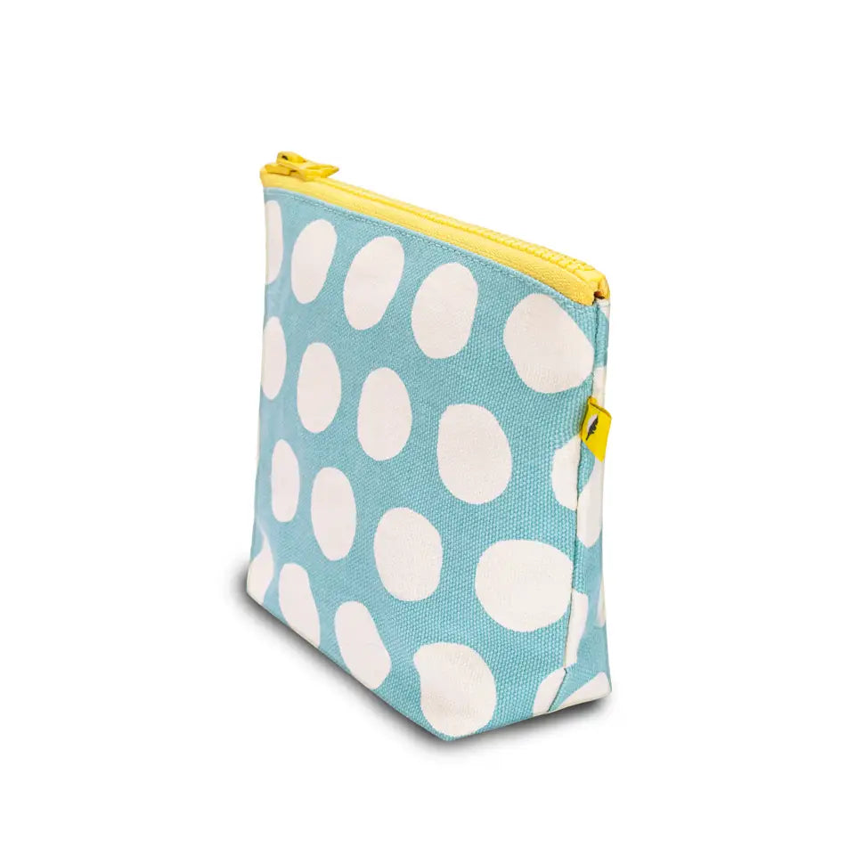 Small blue pouch with large white dots and yellow zipper, made of organic cotton and recycled lining
